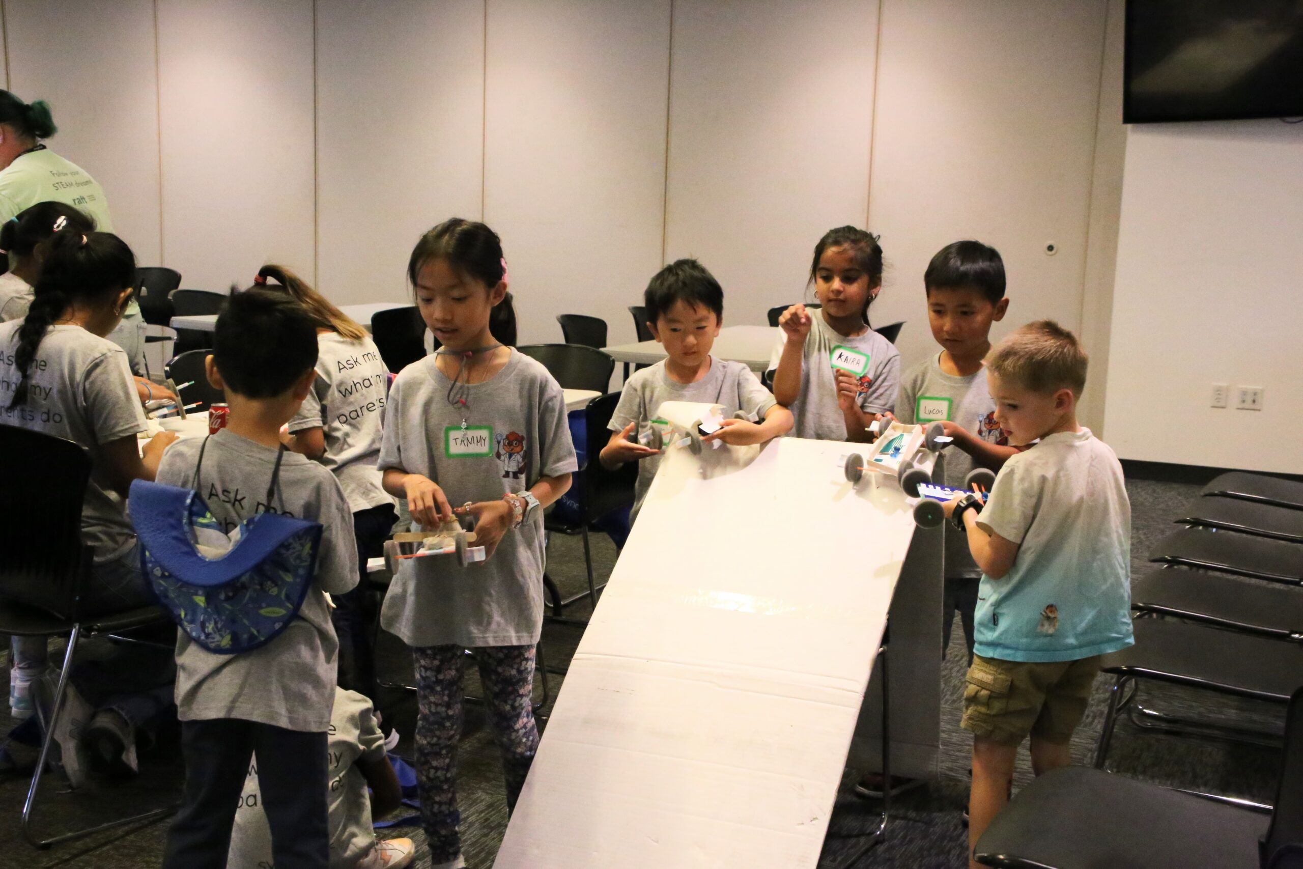 Kids line up at the ramp, ready to put their handmade vehicles to the test in the Car on a Roll challenge. Will their designs pass the speed and safety test?