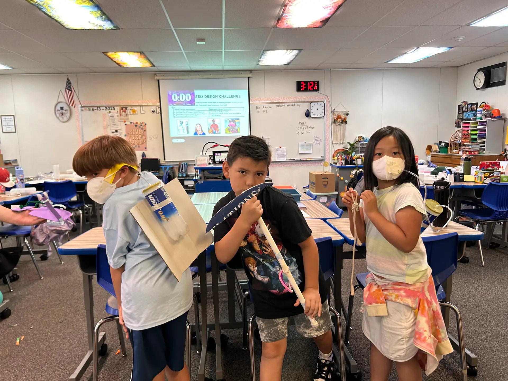 Three proud campers show off their creative ice axe prototypes, designed to keep mountaineers safe during Innovation Lab week.
