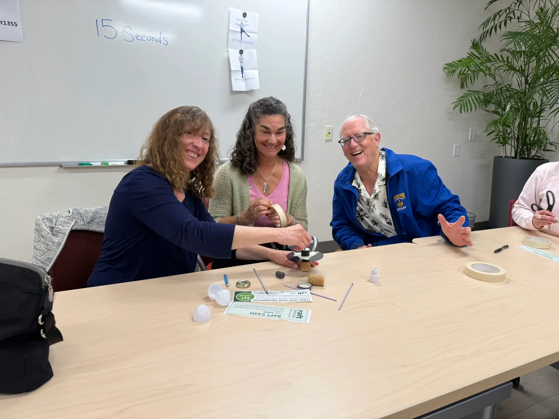 Teachers beaming with joy as they dive into RAFT activities-engaging just like their students during a hands-on spring break training session.