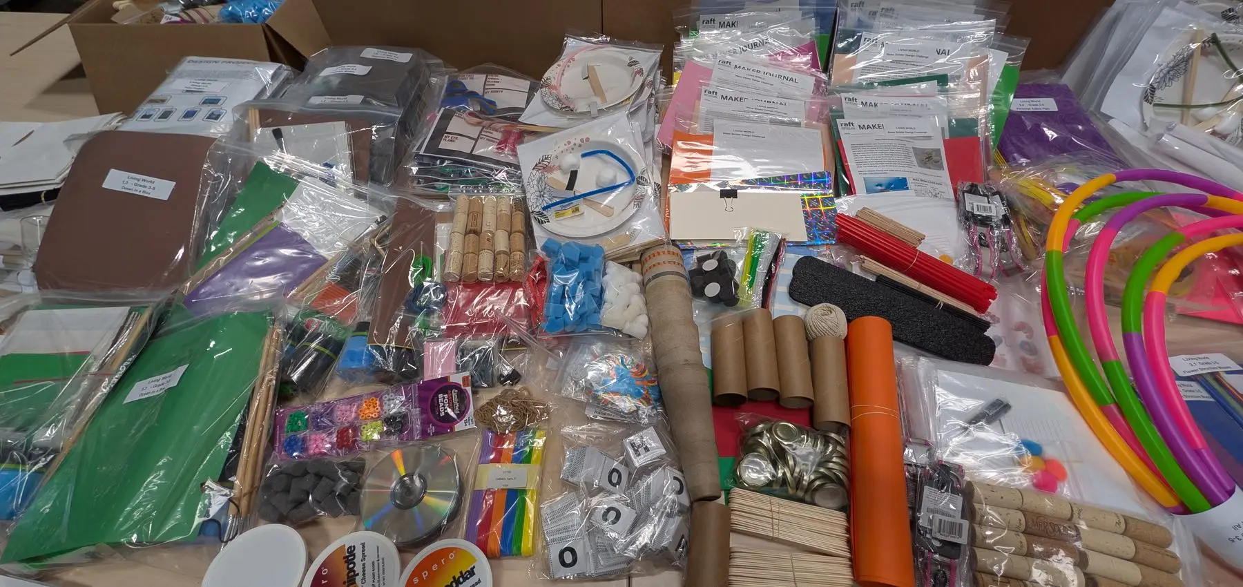 Donated surplus materials sorted and bagged on a table, ready to be built into classroom kits