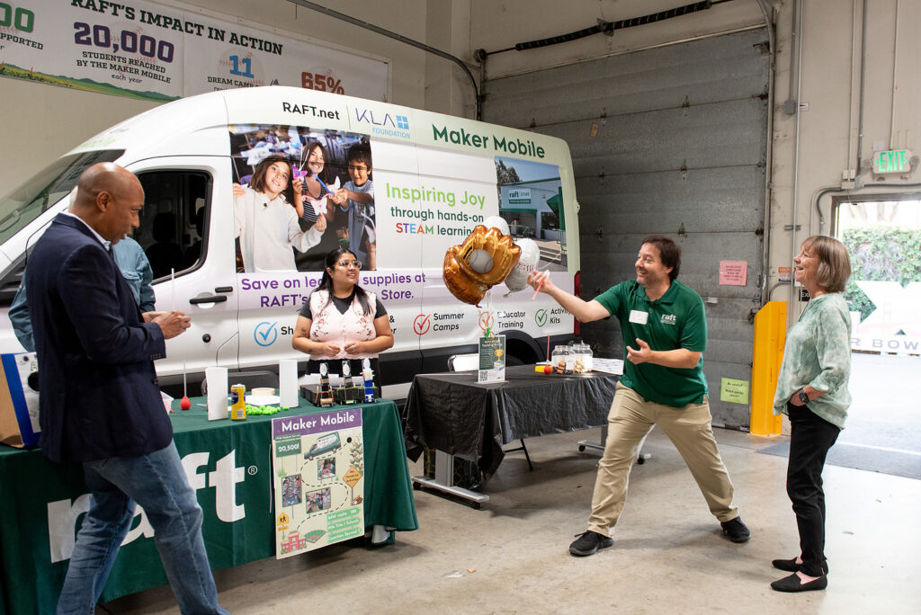 Guests try a hands-on activity at the RAFT Maker Mobile during the Fields of STEAM reception