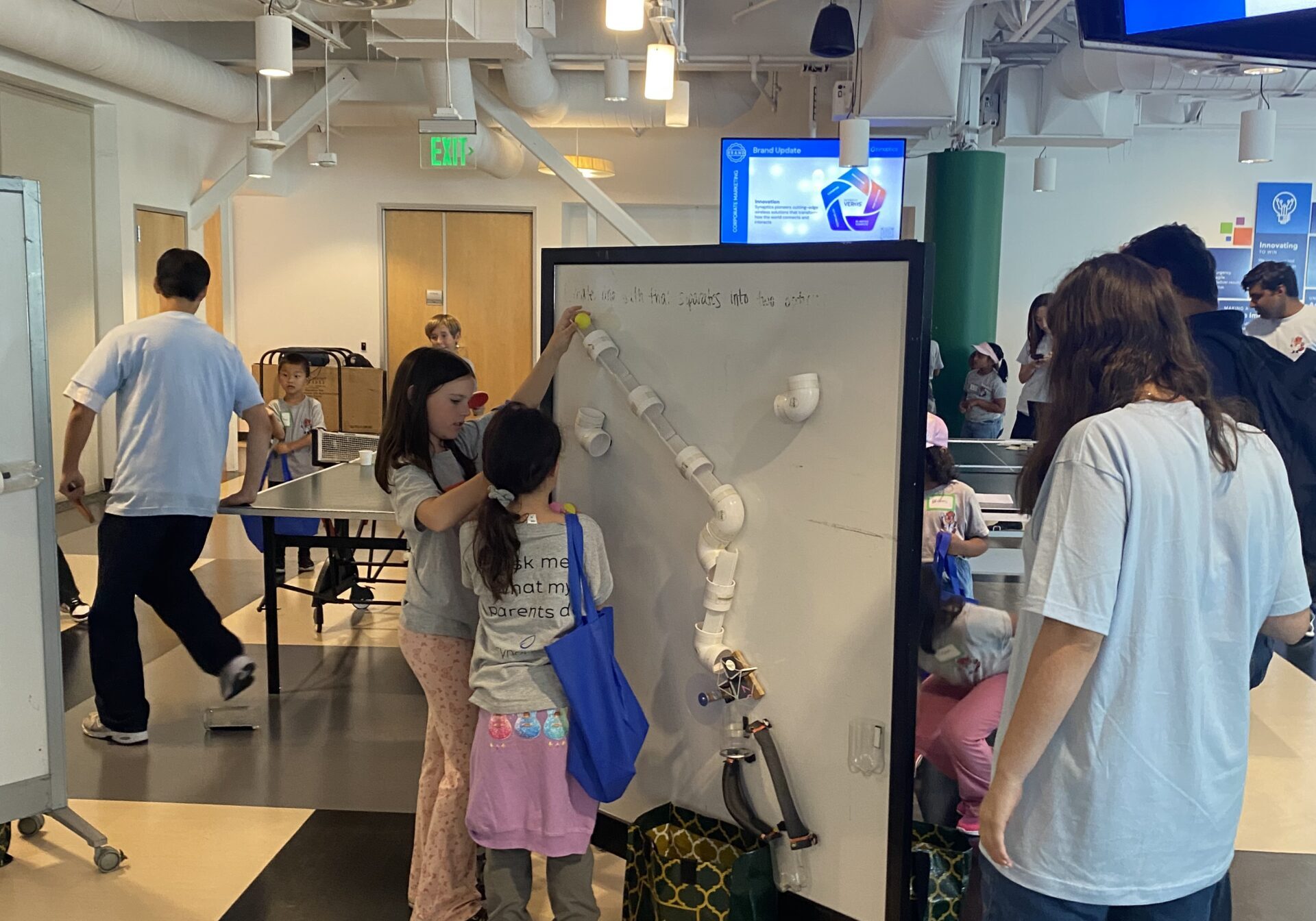Teamwork in action! Kids collaborate to solve a hands-on RAFT STEAM Design Challenge during Bring Your Kids to Work Day.