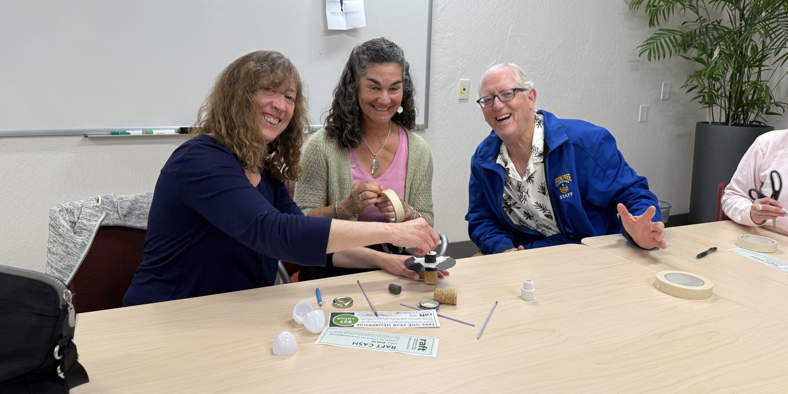 Teachers beaming with joy as they dive into RAFT activities—engaging just like their students during a hands-on spring break training session.